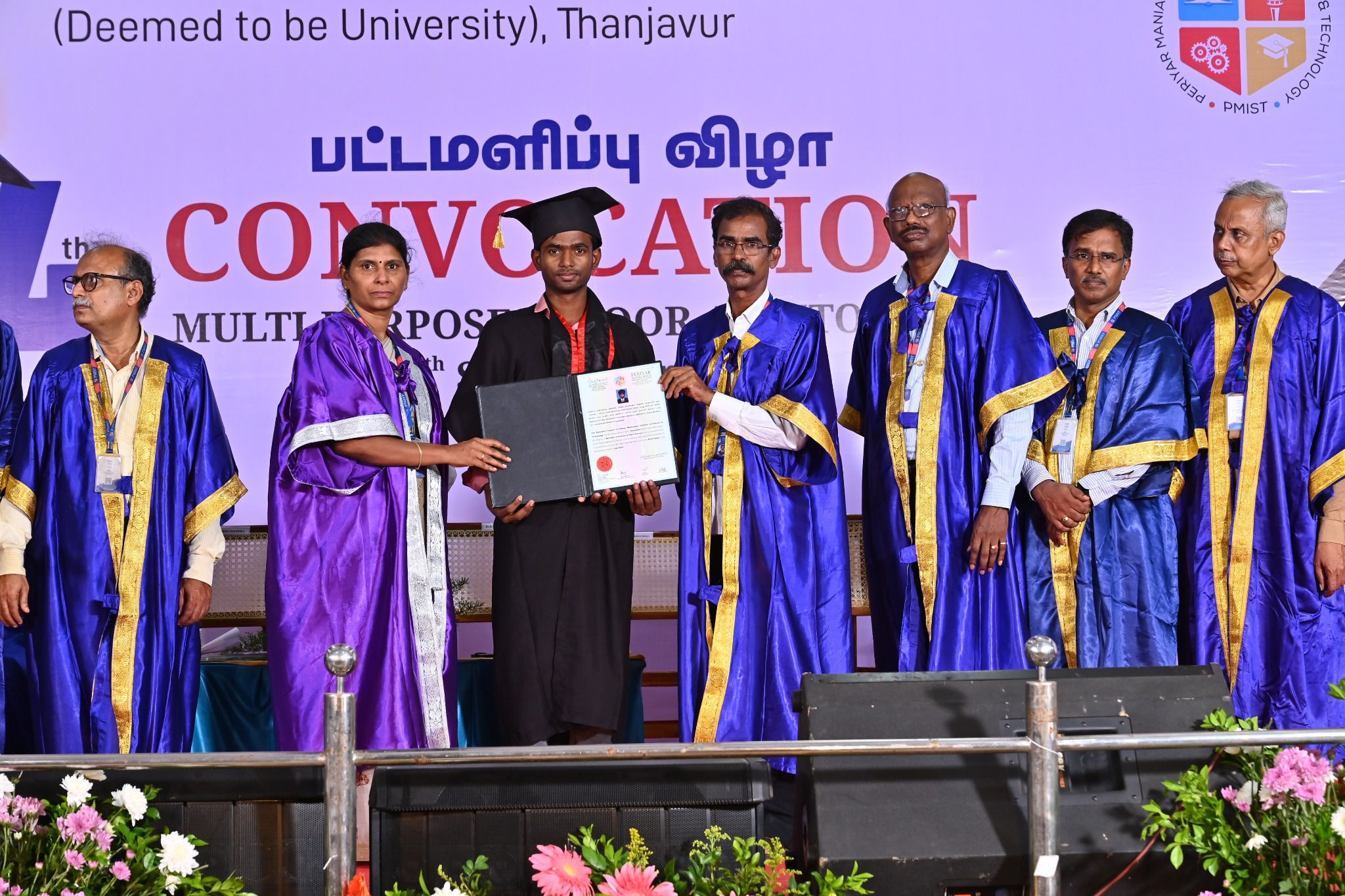 Graduate receiving a certificate on stage at the PMIST convocation