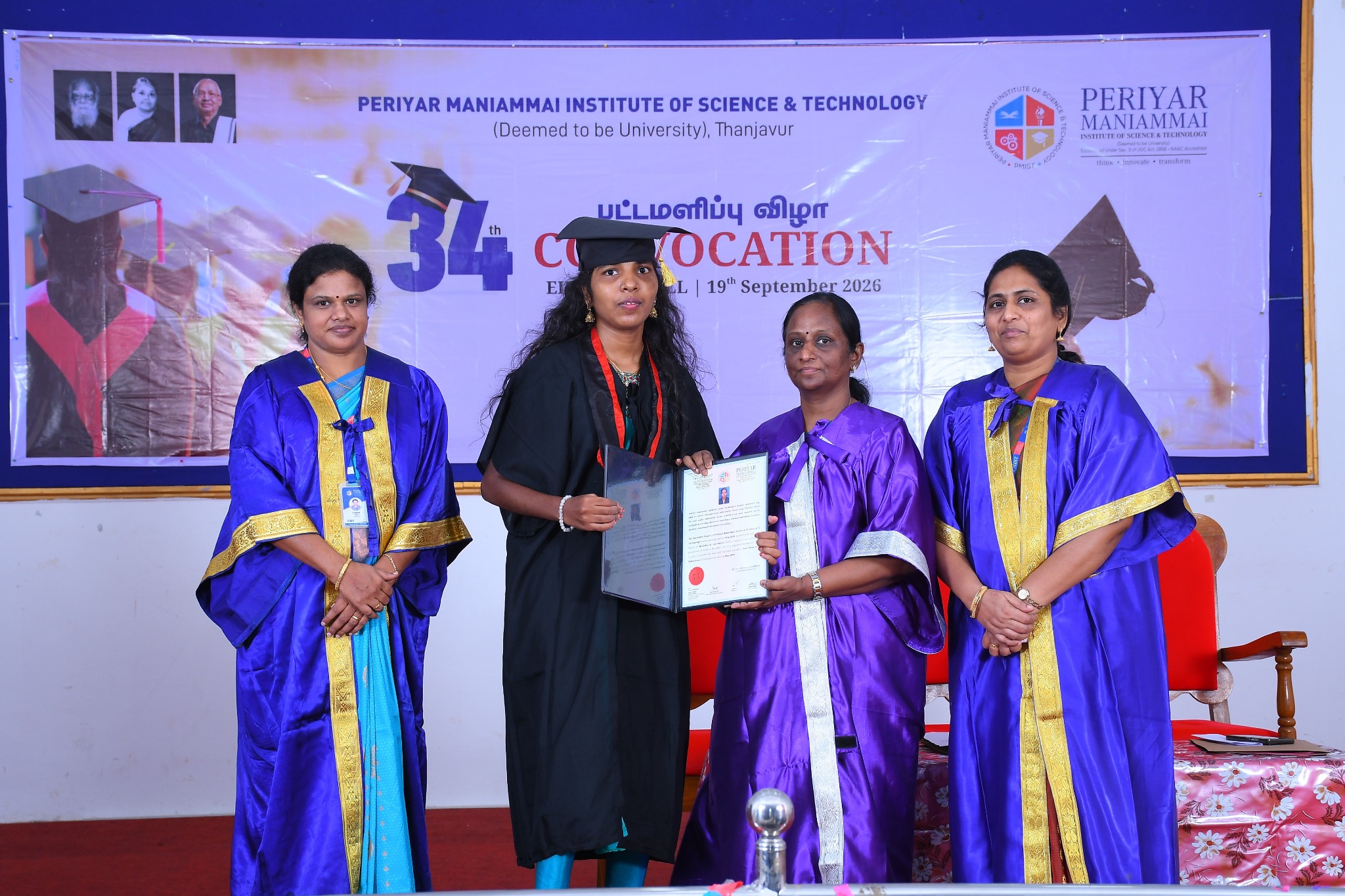 Graduates standing with faculty